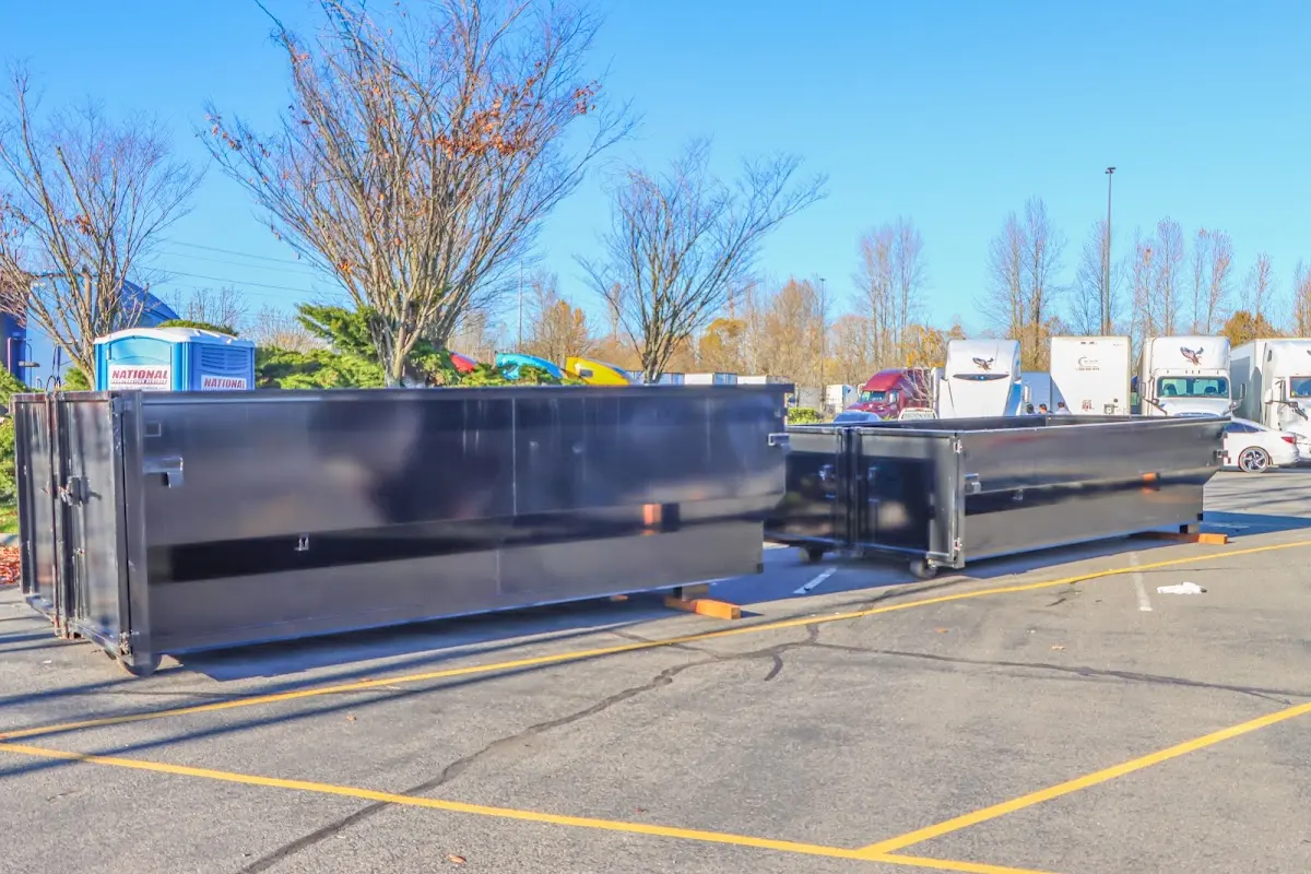 Professional dumpster rental service with roll-off container on residential driveway in Sunny Isles Beach